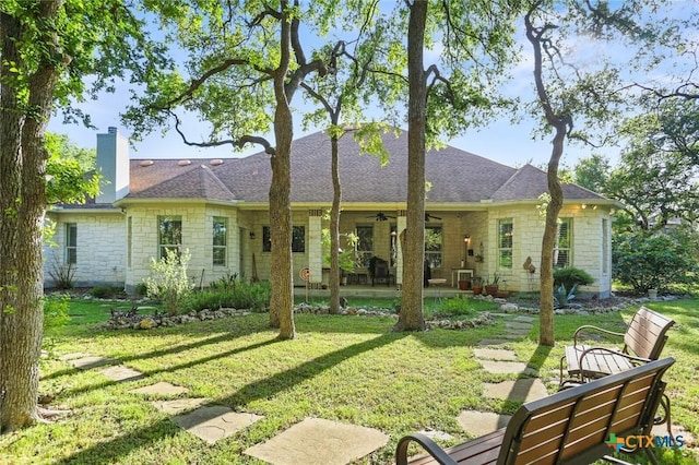 436 Hidden Springs Dr, Spring Branch, TX 78070 - back of house with stone siding, a ceiling fan, a yard, a patio, and a chimney
