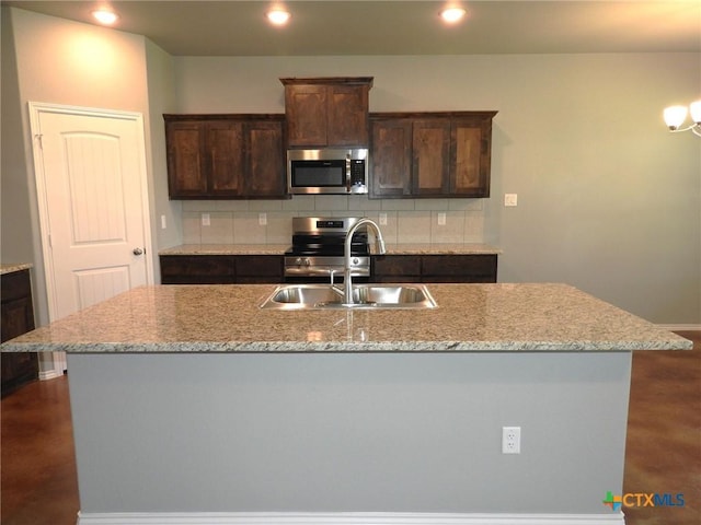 1421 Lindsey Dr, Copperas Cove, TX 76522 - kitchen with stainless steel appliances, a sink, backsplash, dark brown cabinets, and recessed lighting
