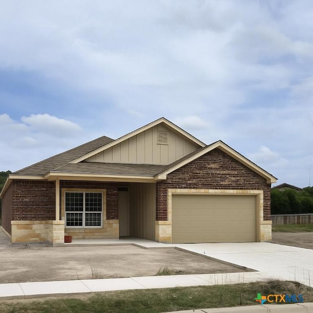 1421 Lindsey Dr, Copperas Cove, TX 76522 - view of front of home featuring brick siding, an attached garage, driveway, stone siding, and roof with shingles
