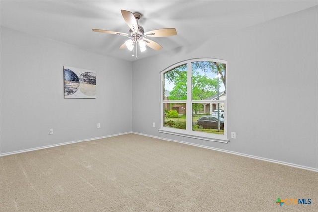 empty room featuring ceiling fan, carpet floors, and baseboards