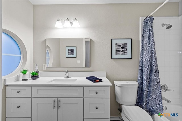 full bath with toilet, shower / tub combo, and vanity