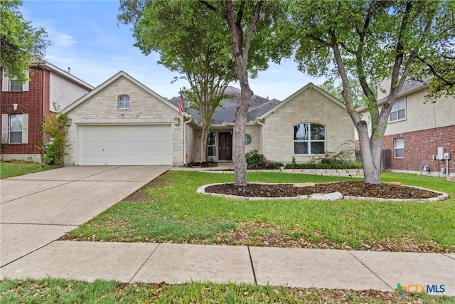 ranch-style home with driveway, a garage, stone siding, and a front yard