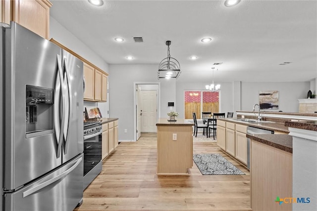 kitchen featuring a sink, recessed lighting, light brown cabinets, a kitchen island, and appliances with stainless steel finishes