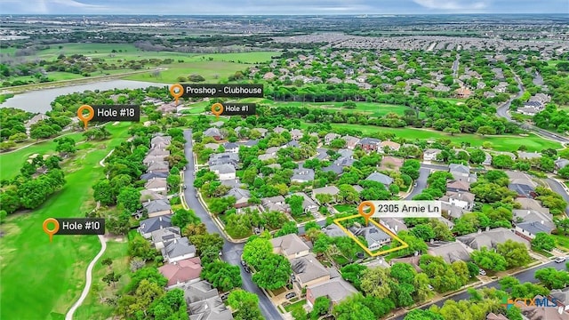 birds eye view of property featuring view of golf course, a water view, and a residential view
