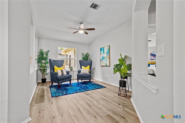 sitting room with baseboards, visible vents, wood finished floors, and a ceiling fan
