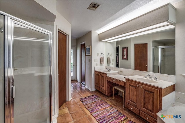 10767 Rosemar Ln, Adkins, TX 78101 - bathroom featuring a shower stall, double vanity, tile patterned floors, and a tub to relax in