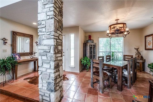 10767 Rosemar Ln, Adkins, TX 78101 - dining space featuring a chandelier, tile patterned flooring, and ornate columns