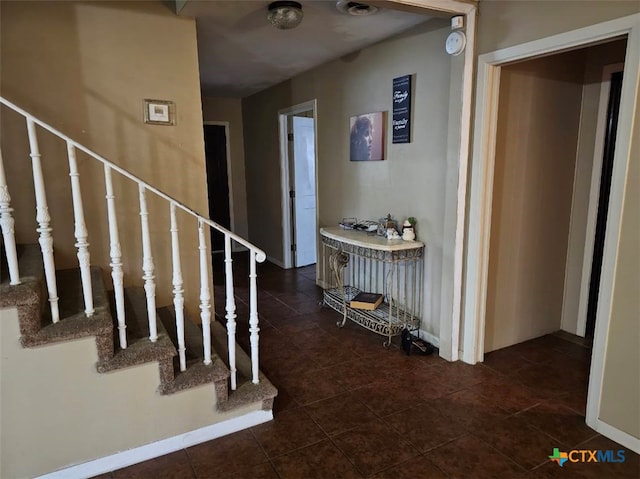 interior space with dark tile patterned flooring