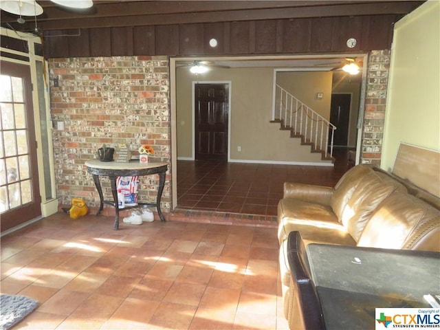 unfurnished living room with tile patterned flooring and ceiling fan