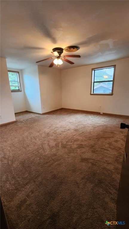 carpeted empty room featuring ceiling fan