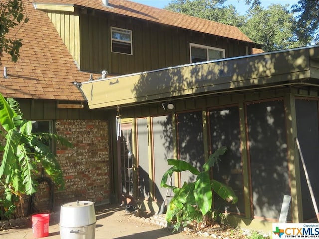 back of property featuring a sunroom