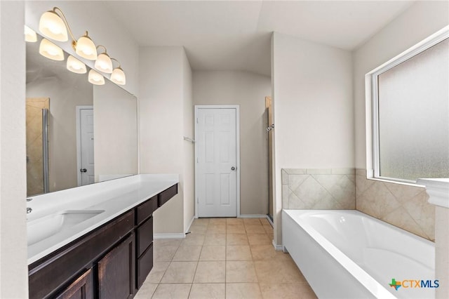 3303 Lorne Dr, Killeen, TX 76542 - bathroom featuring vanity, a garden tub, tile patterned floors, a stall shower, and baseboards
