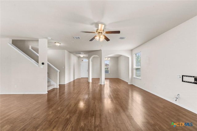 3303 Lorne Dr, Killeen, TX 76542 - unfurnished living room featuring arched walkways, a ceiling fan, wood finished floors, stairway, and baseboards