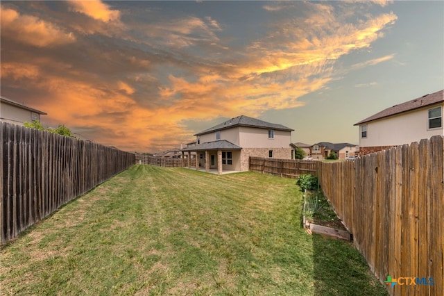3303 Lorne Dr, Killeen, TX 76542 - yard at dusk featuring a vegetable garden and a patio
