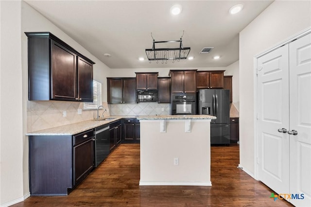 3303 Lorne Dr, Killeen, TX 76542 - kitchen with black appliances, a sink, dark brown cabinets, recessed lighting, and light stone counters