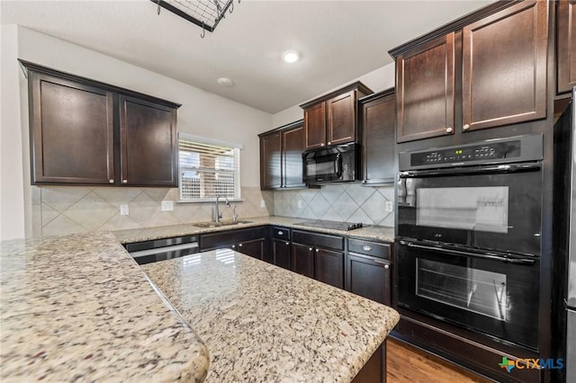 3303 Lorne Dr, Killeen, TX 76542 - kitchen with black appliances, a sink, dark brown cabinets, light stone countertops, and tasteful backsplash