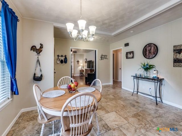 dining space featuring a chandelier, light stone finish floors, and baseboards