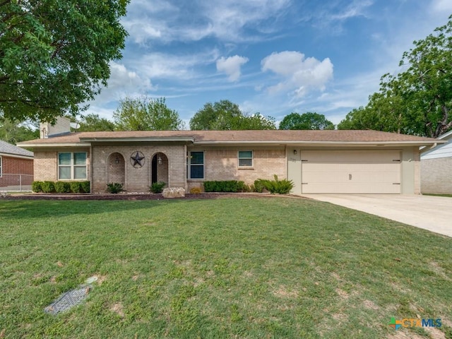 ranch-style home featuring driveway, an attached garage, brick siding, and a front lawn