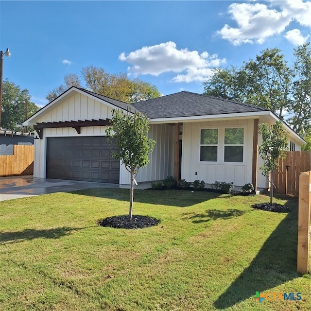 ranch-style home with a front yard and a garage