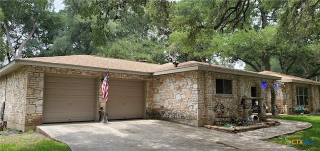 130 Twin Oak Rd, Seguin, TX 78155 - view of front facade featuring stone siding, an attached garage, and concrete driveway