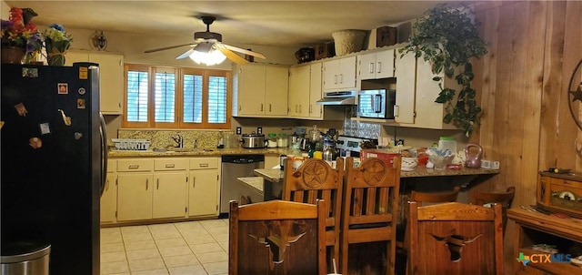 130 Twin Oak Rd, Seguin, TX 78155 - kitchen with appliances with stainless steel finishes, ceiling fan, under cabinet range hood, light tile patterned floors, and a peninsula