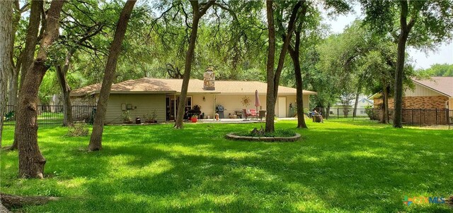 130 Twin Oak Rd, Seguin, TX 78155 - rear view of house with a chimney