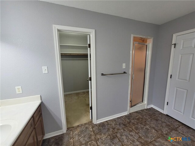 3803 Canyon Heights Rd, Belton, TX 76513 - bathroom featuring a shower stall, baseboards, and vanity