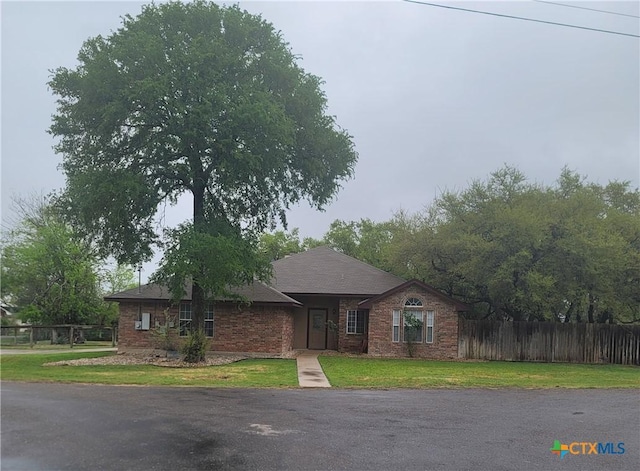 3803 Canyon Heights Rd, Belton, TX 76513 - ranch-style house with brick siding, a front yard, and fence
