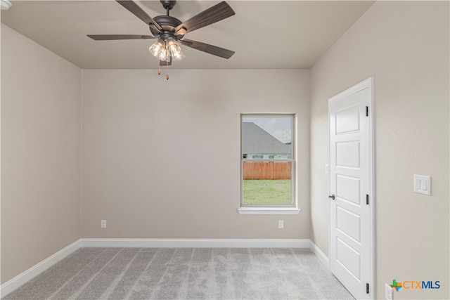 unfurnished room with light colored carpet and ceiling fan