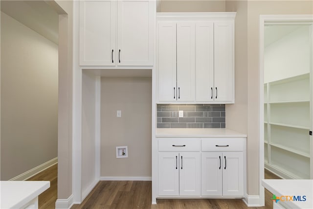 kitchen featuring white cabinetry, dark hardwood / wood-style flooring, and tasteful backsplash