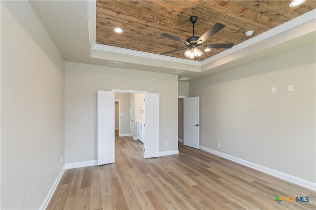 unfurnished bedroom with wood ceiling, ceiling fan, crown molding, a tray ceiling, and light hardwood / wood-style flooring