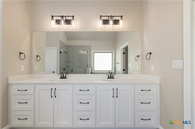 bathroom with vanity and a shower with door