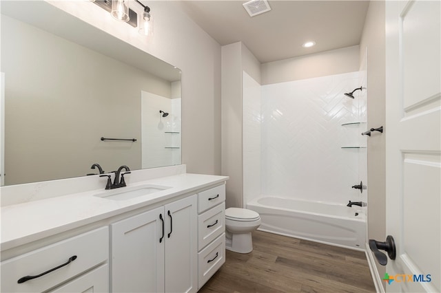 full bathroom with toilet, tiled shower / bath combo, vanity, and wood-type flooring