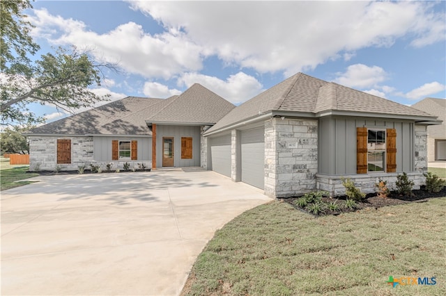 view of front of property with a garage and a front yard