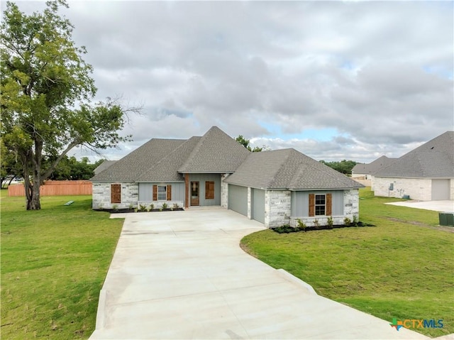 view of front of property featuring a garage and a front lawn