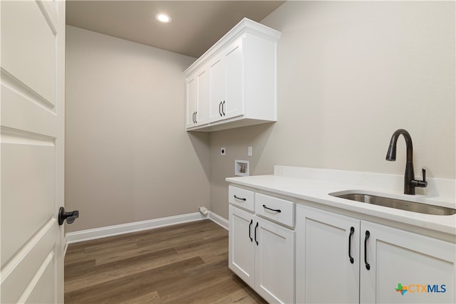 clothes washing area featuring cabinets, sink, hookup for an electric dryer, hookup for a washing machine, and dark hardwood / wood-style flooring