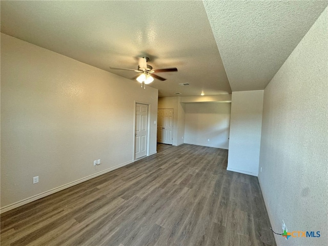 spare room featuring ceiling fan, hardwood / wood-style floors, and a textured ceiling