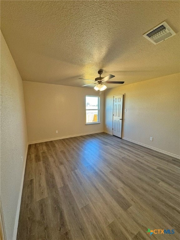 unfurnished room featuring ceiling fan, wood-type flooring, and a textured ceiling