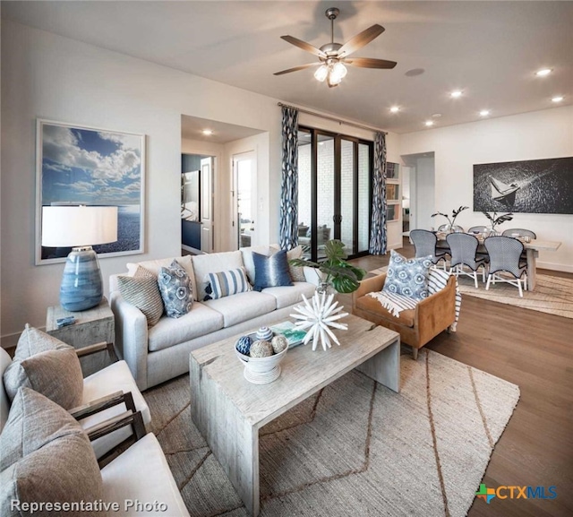 living room with ceiling fan and dark hardwood / wood-style floors