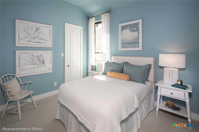 bedroom featuring carpet flooring and lofted ceiling