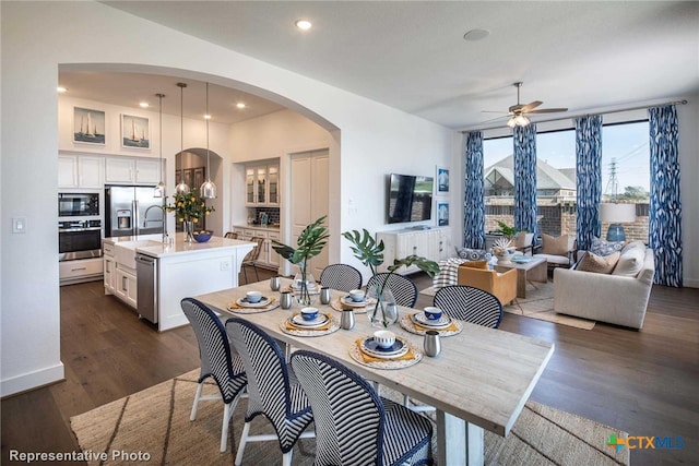 dining space with ceiling fan and dark hardwood / wood-style floors