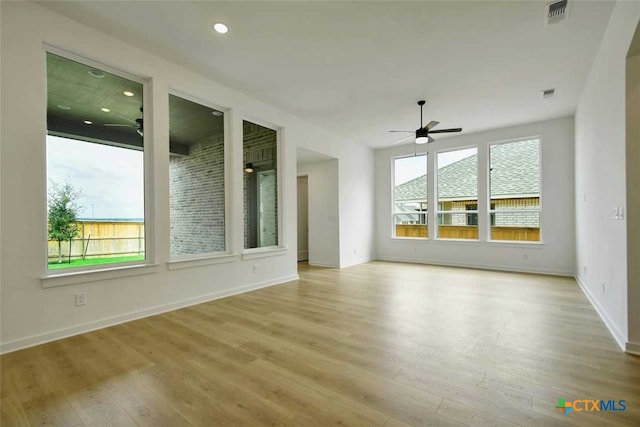 unfurnished living room with light hardwood / wood-style floors and ceiling fan