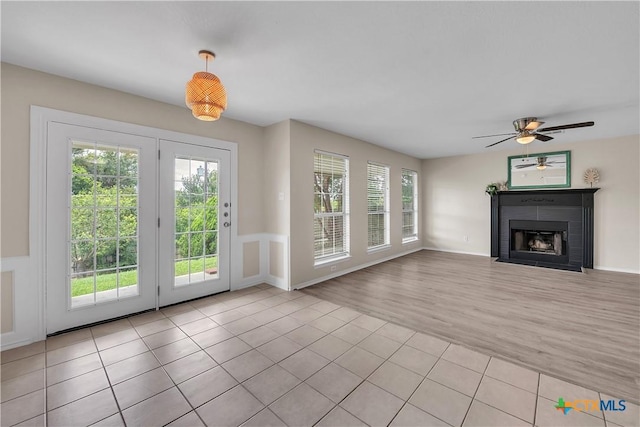 interior space featuring light tile patterned flooring and ceiling fan