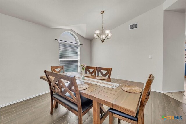 709 Rowdy Dr, Killeen, TX 76542 - dining space featuring wood finished floors, vaulted ceiling, a chandelier, and baseboards