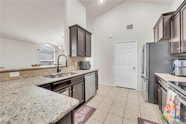709 Rowdy Dr, Killeen, TX 76542 - kitchen featuring a sink, stainless steel appliances, decorative backsplash, light tile patterned flooring, and high vaulted ceiling
