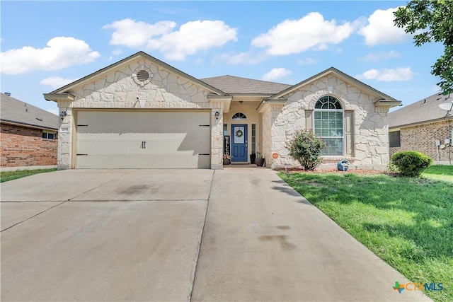 709 Rowdy Dr, Killeen, TX 76542 - ranch-style house featuring stone siding, concrete driveway, a front yard, and an attached garage