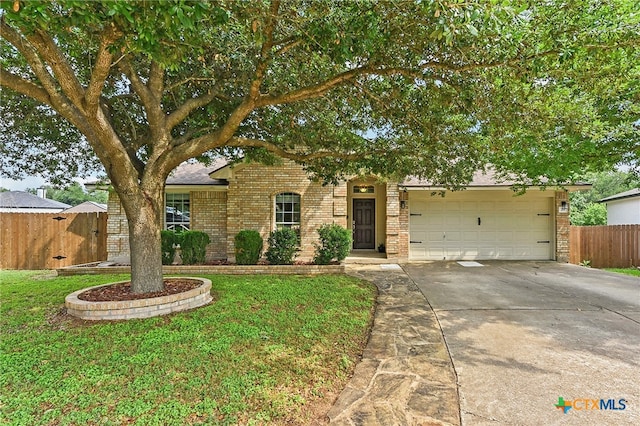 211 Gettysburg Loop, Elgin, TX 78621 - obstructed view of property with driveway, brick siding, a garage, and fence