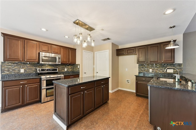 211 Gettysburg Loop, Elgin, TX 78621 - kitchen with baseboards, visible vents, a sink, decorative backsplash, and appliances with stainless steel finishes