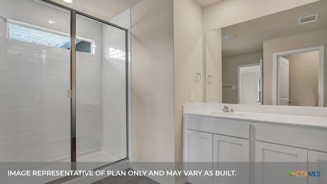 bathroom featuring vanity and a shower with door