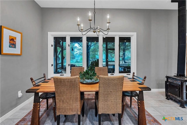 119 Stageline Dr, Kyle, TX 78640 - dining space with a wood stove, a chandelier, healthy amount of natural light, and light tile patterned floors